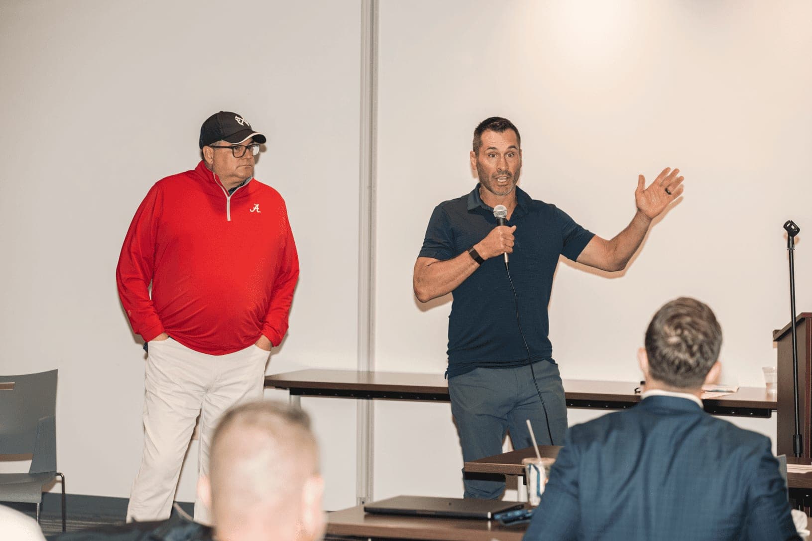 Two speakers presenting to brand owners at a Franchise Accelerator event